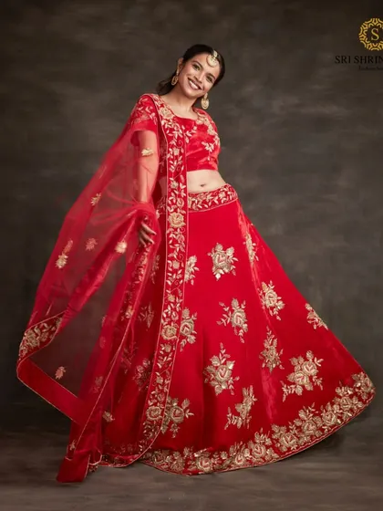 Twirl with happiness in this vibrant red lehenga with gold floral embroidery. It is a joyful and classic choice that is sure to make you the center of attention.
