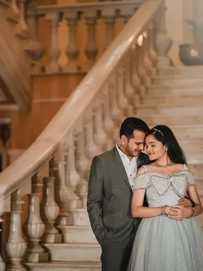 A picture of pure elegance. This couple chose a stunning location for their pre-wedding shoot, with her in a glittering powder blue ballgown and him in a tailored grey suit.