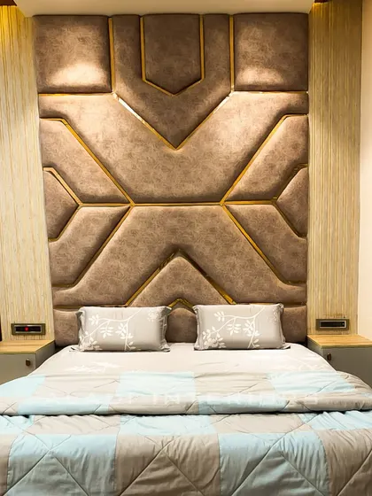 A close-up of the geometric headboard, revealing the intricate gold inlay that adds a touch of luxury and defines the pattern.