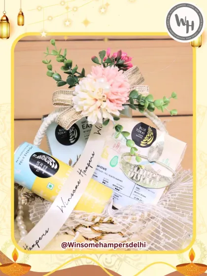 This bright and cheerful hamper features premium Blue Tokai coffee and other gourmet snacks. It's arranged in a lovely basket adorned with artificial flowers and a custom "Winsome Hampers" ribbon, making it a delightful festive surprise.