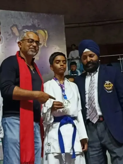 Young champion Shiva being awarded his silver medal at the 2022 National Championship by officials.