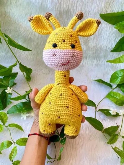 Another view of the handmade giraffe toy, showing his cute little horns and ears.