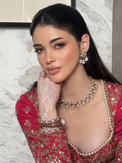 Another angle of the "less is more" philosophy. The white henna on her hand is a beautiful detail, and the soft glam makeup allows it to stand out.