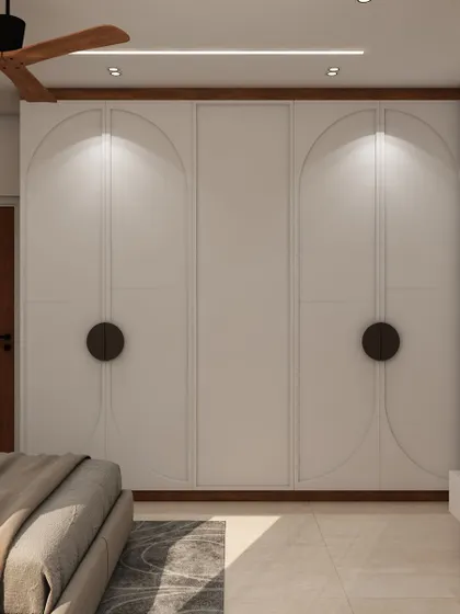 A full view of the wardrobe with a clean, arched design that adds a soft, elegant touch to the room's overall aesthetic.