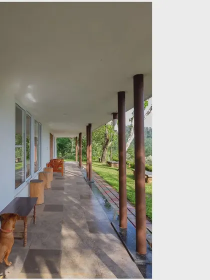 The long, covered verandah is a key feature of this home, providing a shaded space to enjoy the views and climate. It seamlessly connects the interior living spaces with the natural landscape outside.