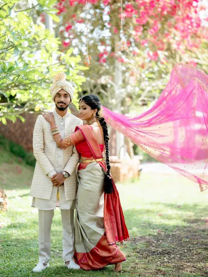 A romantic shot of the couple, with the bride's pink veil creating a beautiful frame.