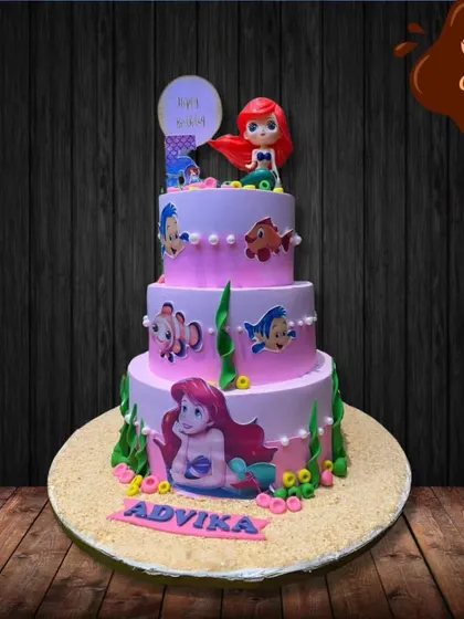 I created this grand, three-tier Little Mermaid cake for a magical fifth birthday. Each layer tells a part of the story, decorated with characters like Ariel and Flounder, edible seaweed, and pearl-like details.