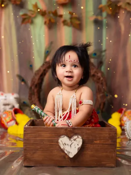 Peek-a-boo! A playful moment with our little Krishna popping out of a wooden box.