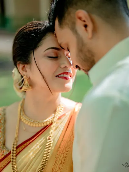A tender moment between the couple, their foreheads touching in a gesture of deep affection and intimacy.
