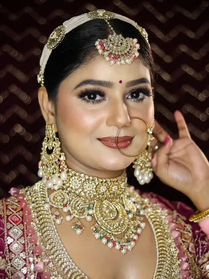 This image captures the complete bridal ensemble, showing how the makeup, hair, and outfit come together. Our training provides a holistic approach to bridal styling.