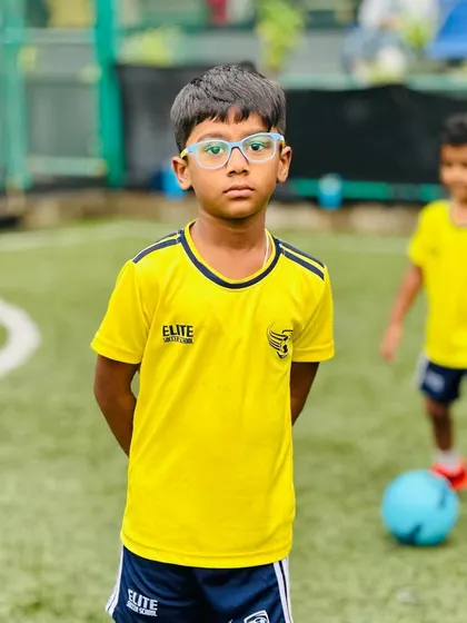 A portrait of one of our focused young players. We aim to develop not just skills but also the discipline and concentration required for the sport.