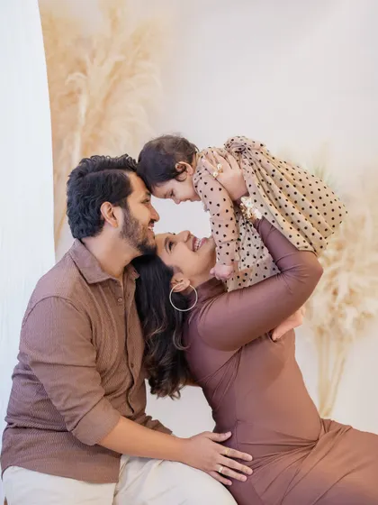 The purest connection between a mother, father, and their baby girl. This image from a first birthday family session shows the playful, loving bond that I aim to capture in every frame. These are the moments you'll treasure forever.
