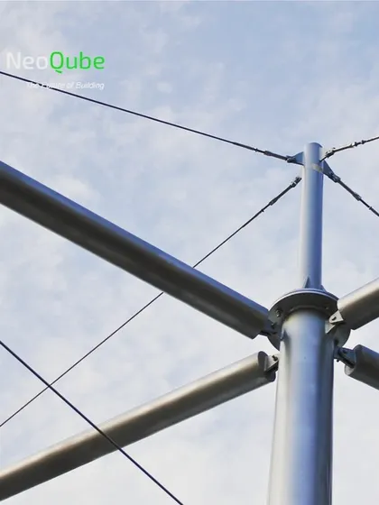 A close-up of the engineering behind our tensile structures. This image shows the steel mast, connection points, and tension cables that form the backbone of a durable and elegant cable-supported membrane canopy.
