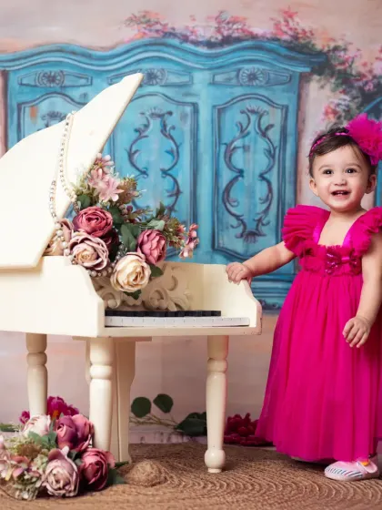 A little musician in the making! This happy girl is celebrating her first birthday with our vintage piano prop.