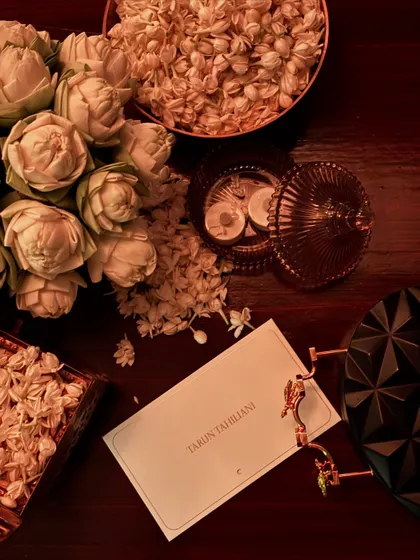 It's not just about the clothes. The ambiance at a couture show, like this display of fresh flowers and a personalized note from Tarun Tahiliani, sets the tone for the entire experience.