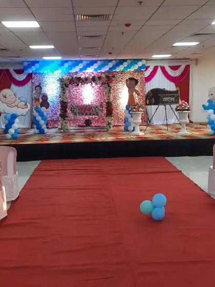 A wider view of the Chhota Bheem themed naming ceremony, showing the full stage and aisle.