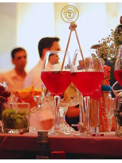A pair of our signature red wine cocktails, garnished with fresh fruits and herbs. Perfect for a sophisticated evening event.