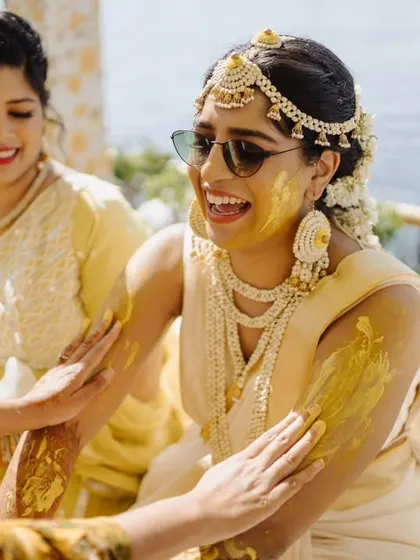 A fun-filled Haldi ceremony in Udaipur, where the couple, dressed in traditional white and gold, danced and celebrated by the pool.