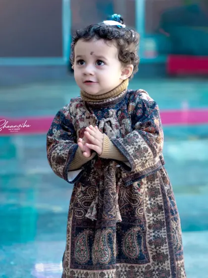 A candid shot of a toddler with an innocent, thoughtful expression. I love capturing these quiet, in-between moments during a children's portrait session.