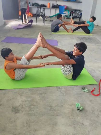 The partner boat pose is a fun challenge that works the core muscles and hamstrings. It also requires communication and cooperation to find the perfect point of balance.