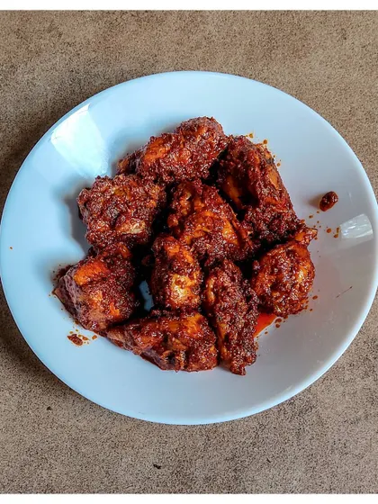 My version of Chicken Ghee Roast, a classic from Kundapura. I use a special blend of spices to create the iconic red masala that coats the tender chicken pieces.