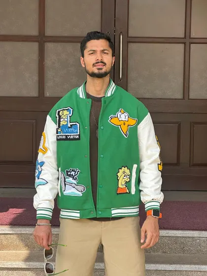 A slightly more relaxed pose in the same jacket, conveying a casual and approachable vibe.