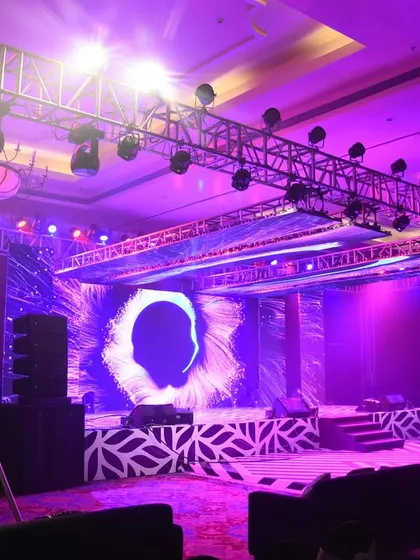 A stage ready for a rockstar performance. The setup includes a full lighting rig, a large LED screen with abstract visuals, and a powerful sound system, designed to create an electrifying concert-like experience.