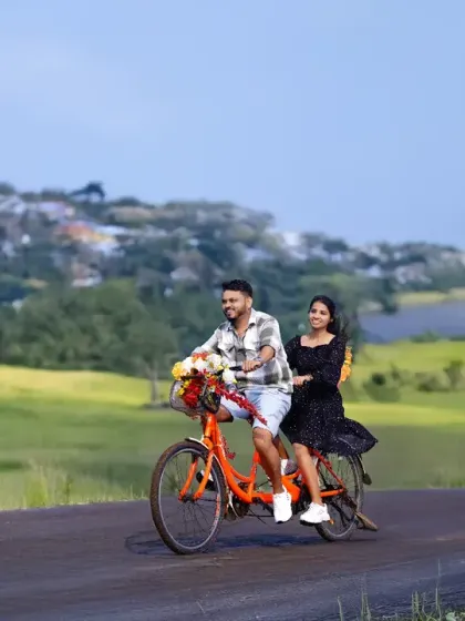A tandem bicycle ride through a scenic, green landscape. This pre-wedding shot captures a sense of journey and partnership in a beautiful, natural setting.