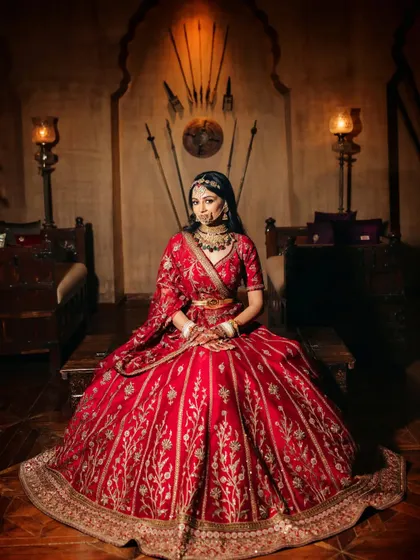 A powerful portrait of the bride seated in a room with royal Marwari decor, looking every bit a queen.