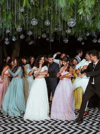 More dancing and fun at the sangeet, with the decor creating a perfect backdrop for candid moments.