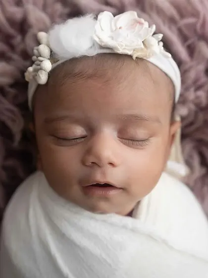 The serene face of a sleeping newborn. My goal is to capture this fleeting stage with grace and beauty.