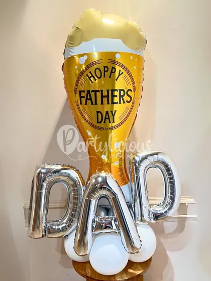 A fun and "hoppy" Father's Day balloon arrangement. The beer mug foil balloon paired with "DAD" letter balloons is a playful way to celebrate him and his favorite things.
