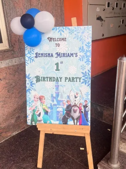 A welcome sign for a "Frozen" themed first birthday party, featuring characters from the movie.