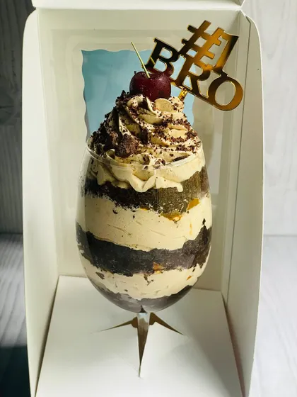 The Mocha Mirage Delight for Rakhi, shown in its custom box that holds the glass securely in place. The "#1 Bro" topper makes it a perfect gift for your brother.