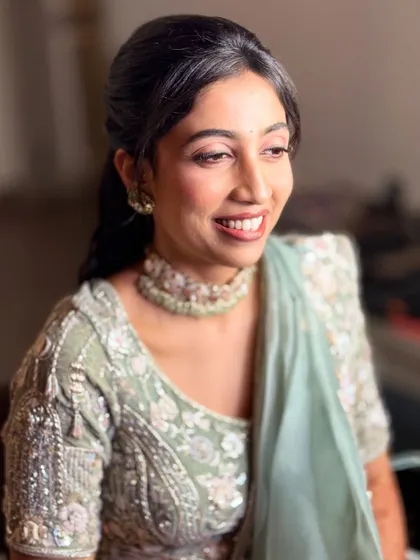 Another beautiful smile from Neha. The makeup is designed to look flawless from all angles, ensuring she looks perfect in every photo.