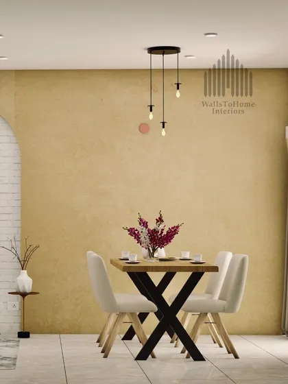 A minimalist dining setup with a textured accent wall and modern pendant lighting. This design proves that simplicity can be incredibly sophisticated and inviting.