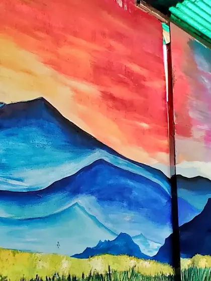 A close-up on the painted mountains, showing the layering of blues and purples to create a sense of distance and depth.