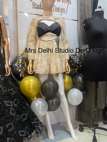 The winter dress displayed next to a mannequin, showing its unique silhouette and design.