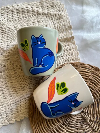 Our popular blue cat mugs are now available on a new off-white base, which really makes the colors pop.