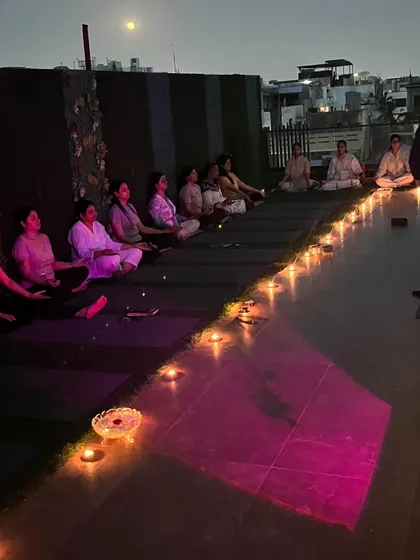A wider view of our rooftop full moon ceremony. The combination of the open night sky, the city lights below, and the glow of the candles creates a truly magical and sacred space for our practice.