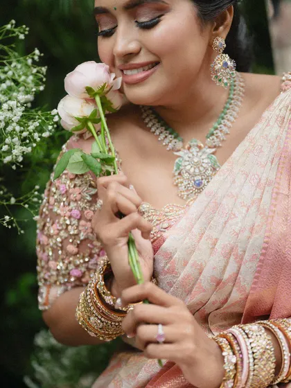 A close-up of the delicate 3D floral embroidery on this pastel pink blouse. This technique adds a beautiful texture and a touch of romance to the design.