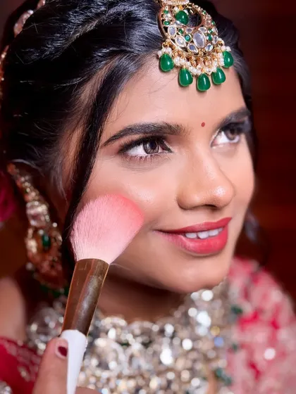 A close-up of the blush application process. It's these small, precise steps that build up to a flawless final look.