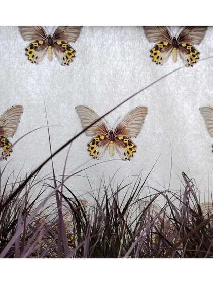 The 'Tabati' fabric, featuring delicate butterflies on a white background, is perfect for adding a bit of lighthearted whimsy to a bedroom or a child's playroom.