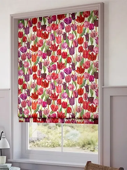 A beautiful floral printed Roman blind featuring a pattern of colorful tulips. This style adds a classic, soft touch to the room while providing excellent light control and a decorative flair.