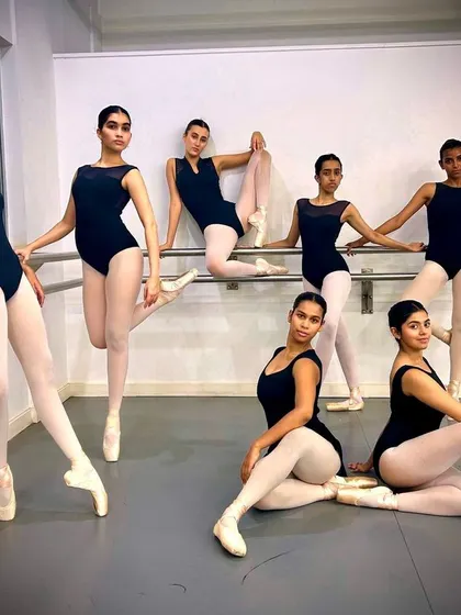 Posing at the barre. The ballet barre is fundamental to our daily training, and it serves as a great setting to showcase our dancers' form and technique.