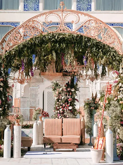 A beautifully designed seating area for a Bhaat ceremony, where every detail, from the floral arrangements to the intricate mandap, exudes charm and grace. This setup at The Leela Palace was created to be an unforgettable setting for a once-in-a-lifetime moment.