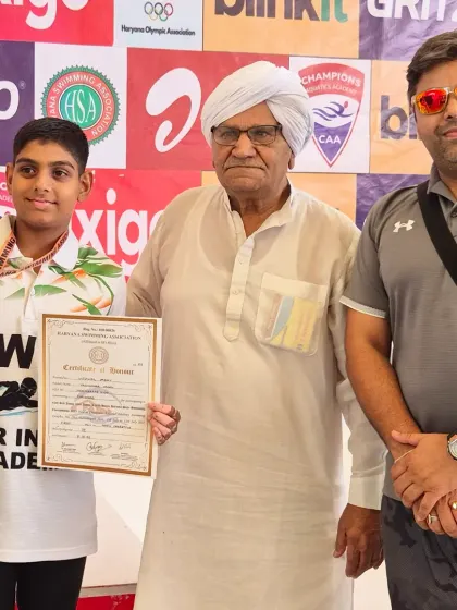 Ujjwal Yadav receiving his gold medal and certificate at the Junior Haryana State Swimming Competition. A proud moment for him and his family.