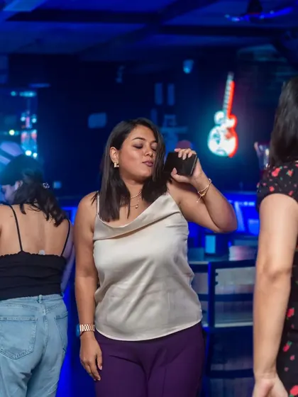 A guest dancing and singing along, phone in hand. The vibe is modern, fun, and perfect for capturing every moment.