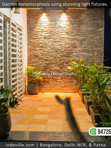 A duplicate image of the stone accent wall and potted plants, showing how simple lighting can transform a space.