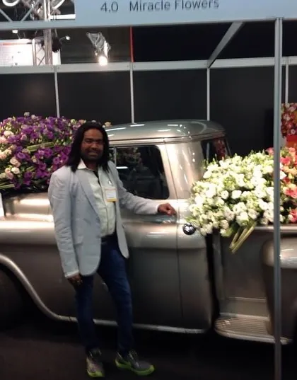 At an expo in the Netherlands, standing next to a vintage truck overflowing with flowers. This kind of creative, large-scale floral display is a huge source of inspiration for event decor.